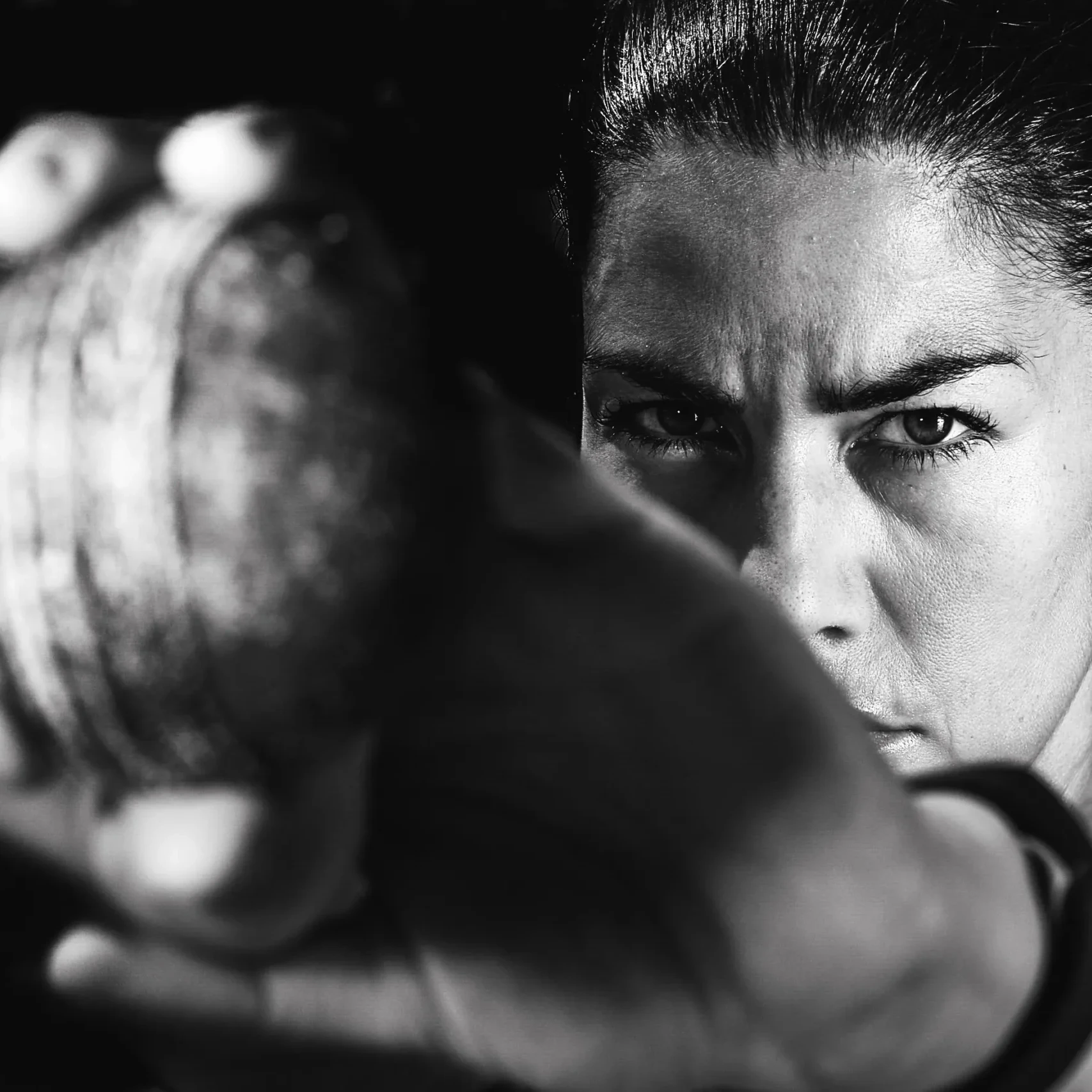 Focused woman gripping a ball and looking at the camera