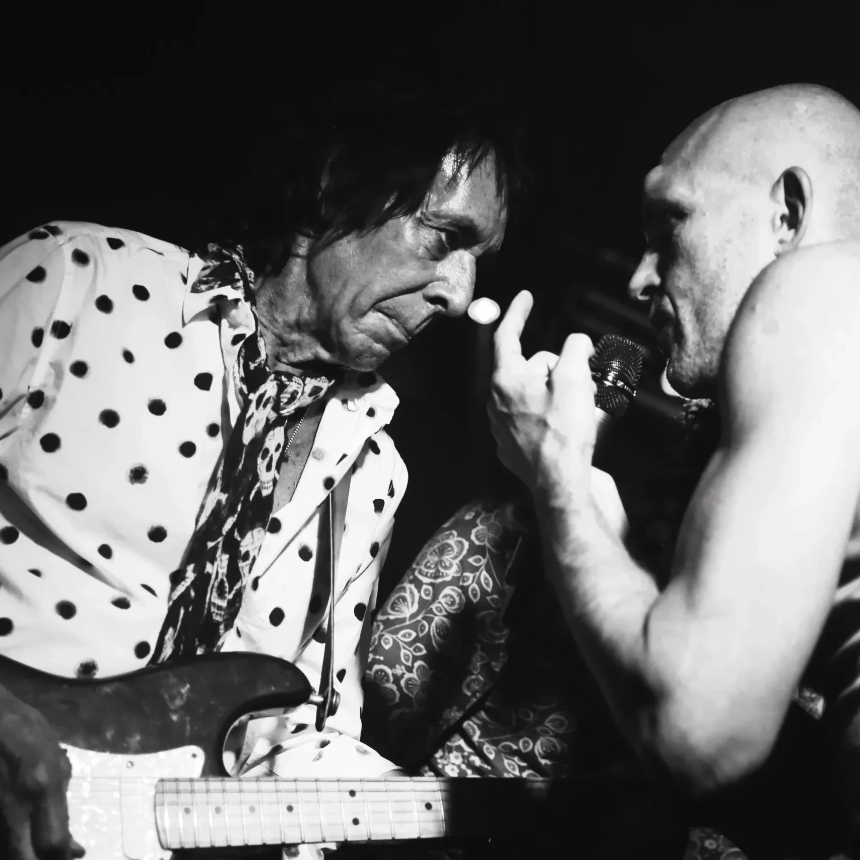 Two men in a close face-to-face conversation