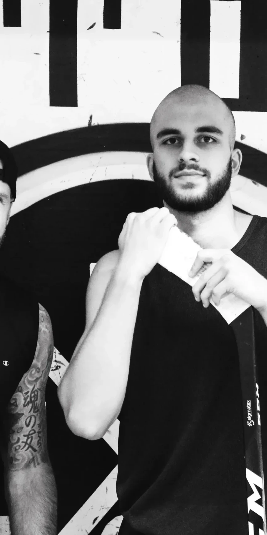 Two men in boxing stance in a gym
