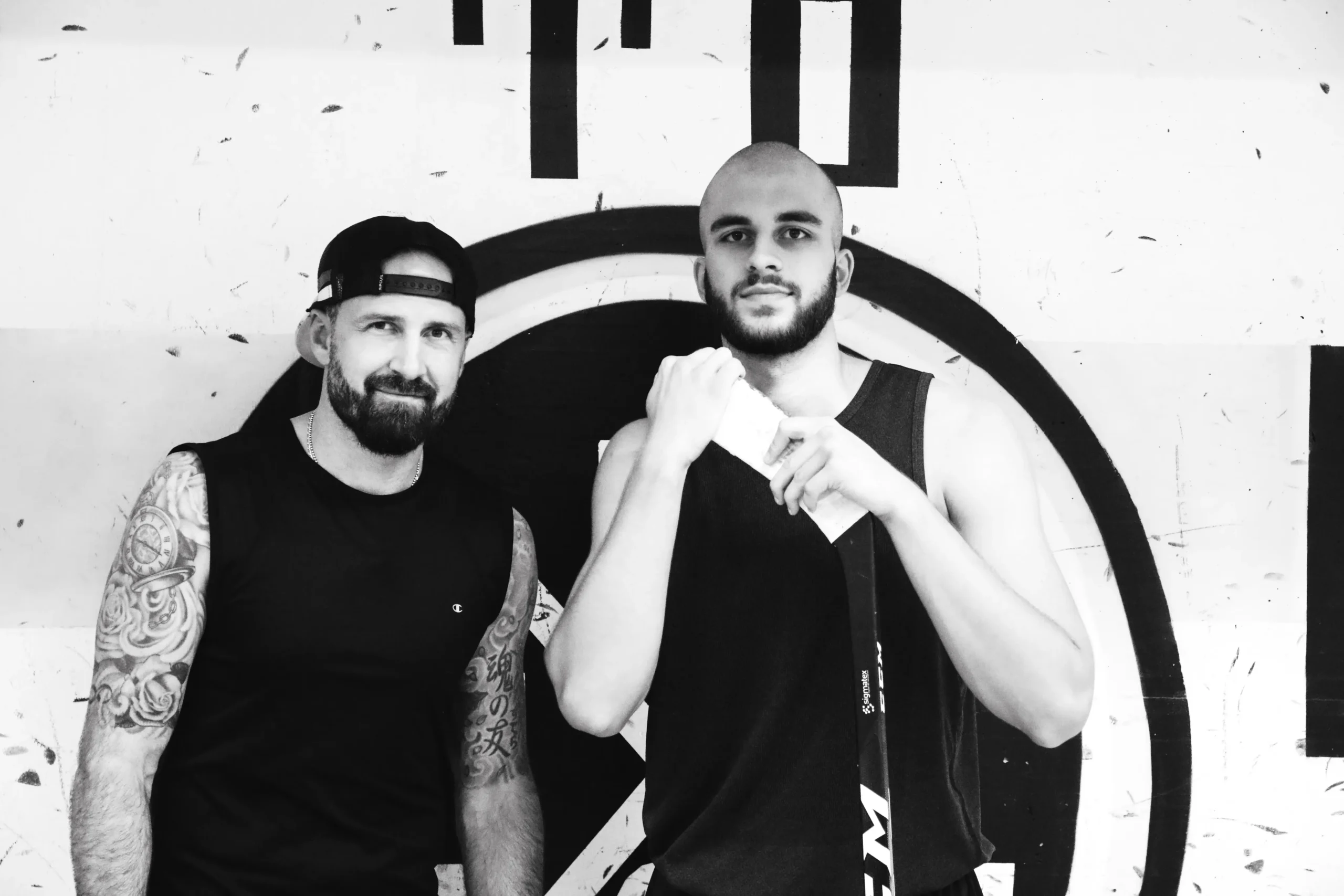 Two men in boxing stance in a gym