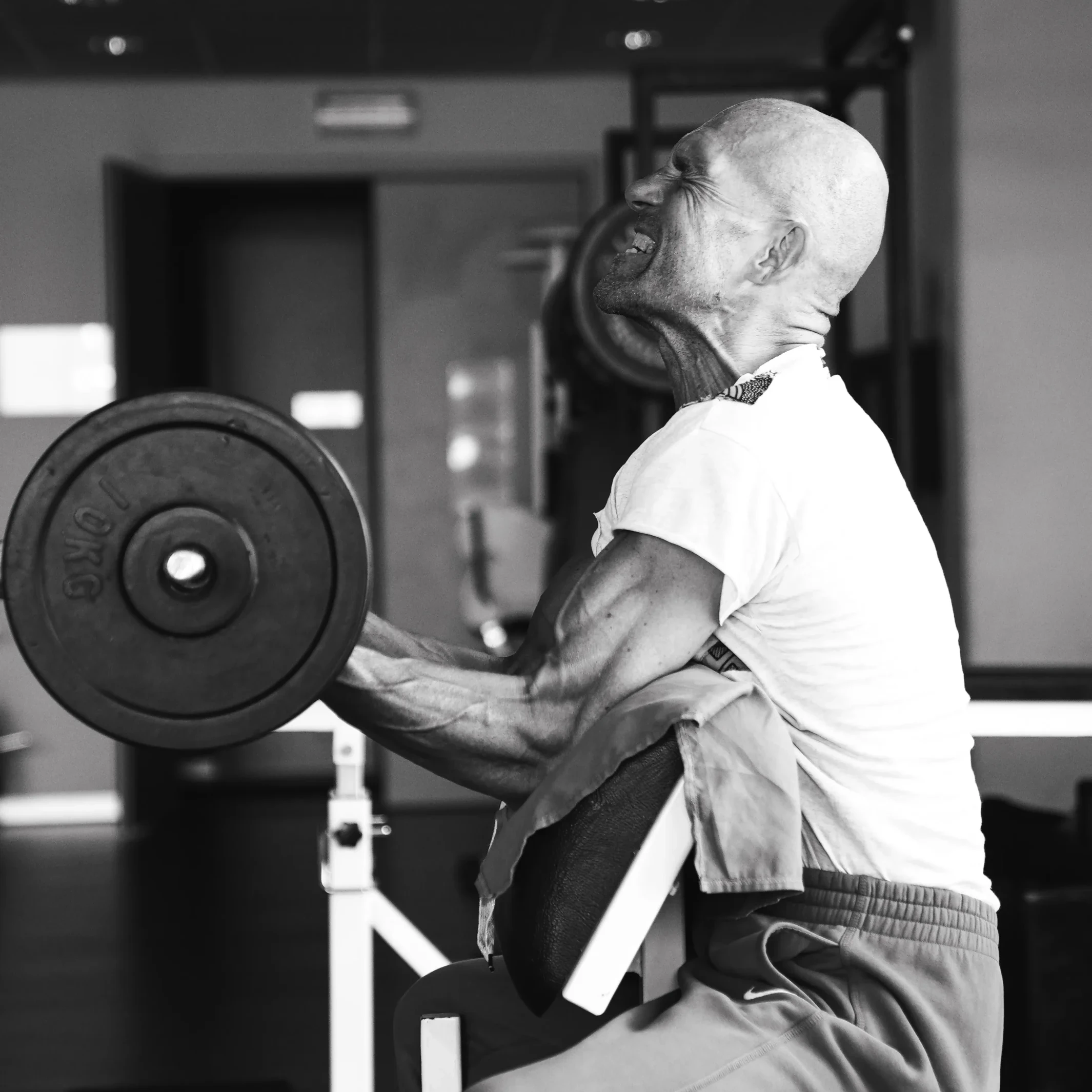 Woman handling a barbell plate during strength training
