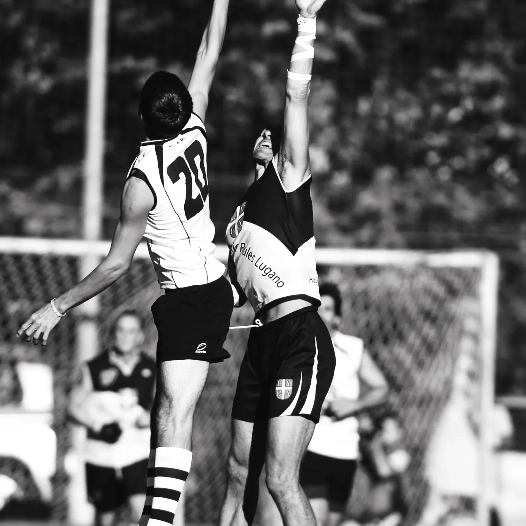 Football players jumping for the ball in front of the goal